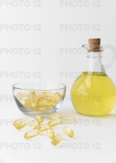 Omega 3 fish oil capsules and bottle on white background