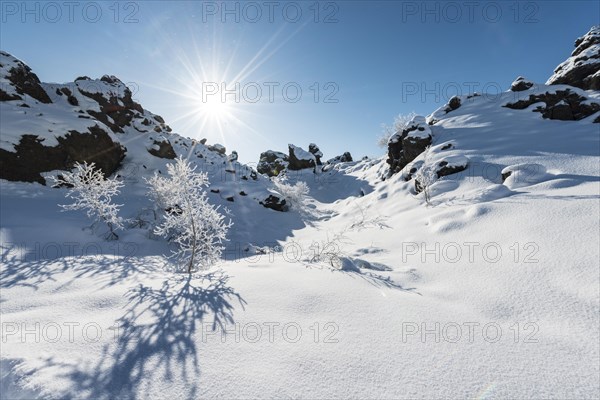 Sun shines on snow-covered lava field