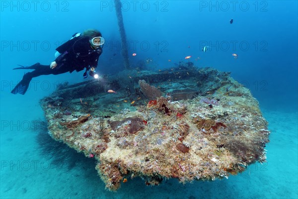 Divers with Lamp Viewed Coral-covered Bow