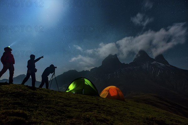 Three photographers backpacking in front of the Les Aiguilles d'Arves mountain