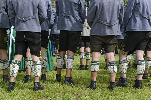 Men in leather trousers and traditional Loferl