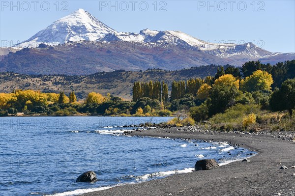 Lake Lago Lolog in autumn with the snow-covered volcano Lanin