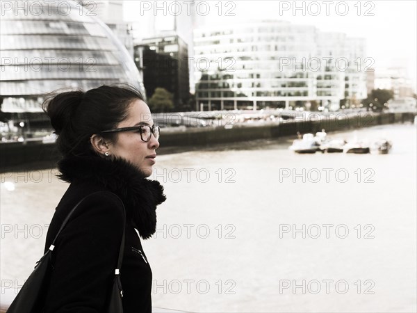 Young woman looks over the Thames