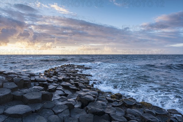 Basalt columns by the coast at sunset