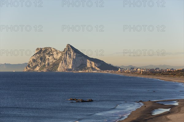 View of The Rock of Gibraltar and La Linea de la Concepcion as seen from the Mediterranean coast in the early morning light