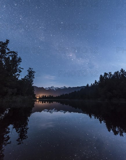 Mt. Tasman and Mt. Cook at night with stars and Milky Way