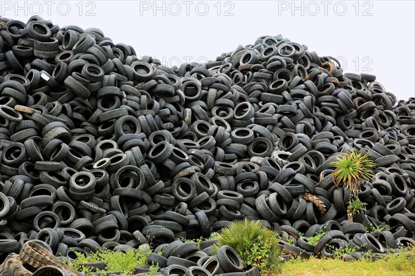 Old car tires lying on a pile for recycling