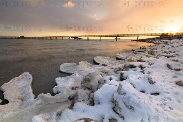 Sunrise with ice and snow on the shore of Lake Constance