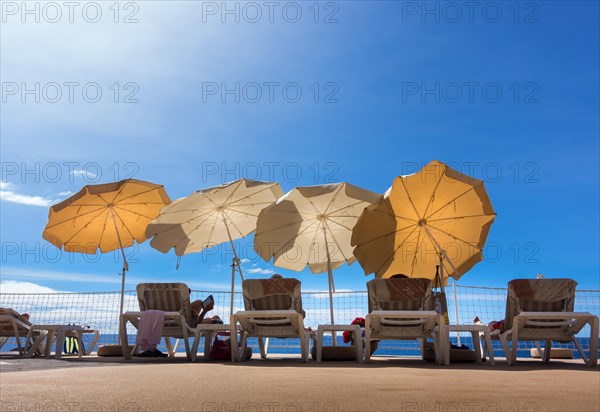 Parasols and sun loungers on a patio