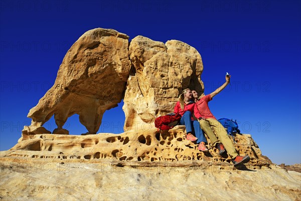 Hikers climb Elephant Rock outside of Petra