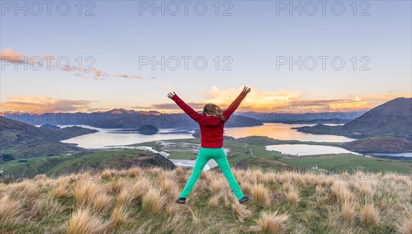Hiker jumping with limbs spread out in the air