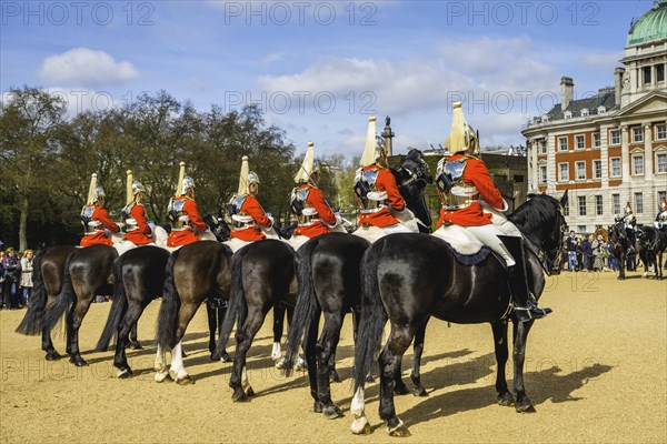 The Royal Guards in red uniform on horses