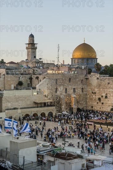 Believers at the Wailing Wall at dusk