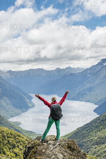 Female hiker is looking at the South Fiord of Lake Te Anau