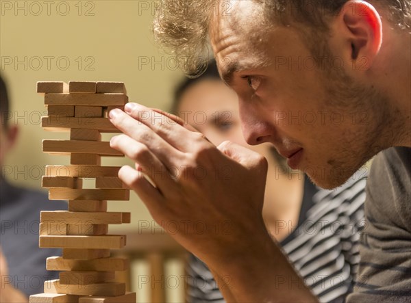 Young man plays Jenga