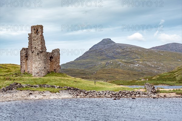 Castle ruin Ardvreck Castle on a peninsula by lake Loch Assynt