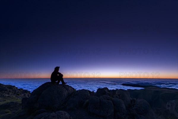 Sunrise with person on mountain peak