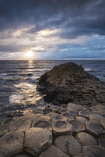 Basalt columns by the coast at sunset