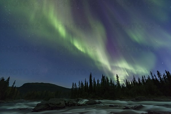 Northern Lights or Aurora Borealis above river Gamajahka or Kamajakka