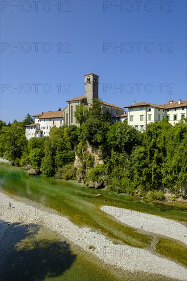 View over the river Natisone to the Campanile of the cathedral Santa Maria Assunta and the old town