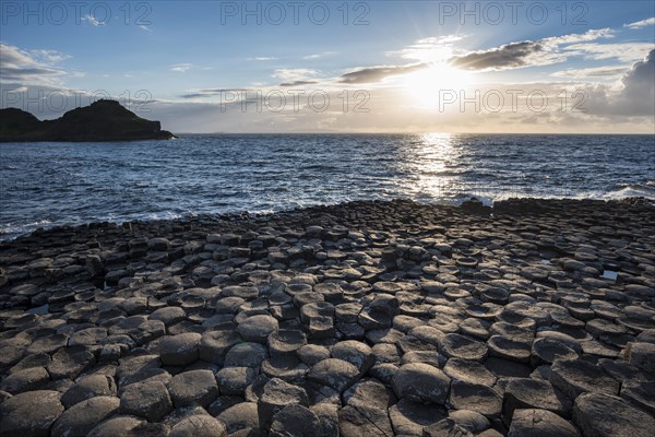 Basalt columns by the coast at sunset