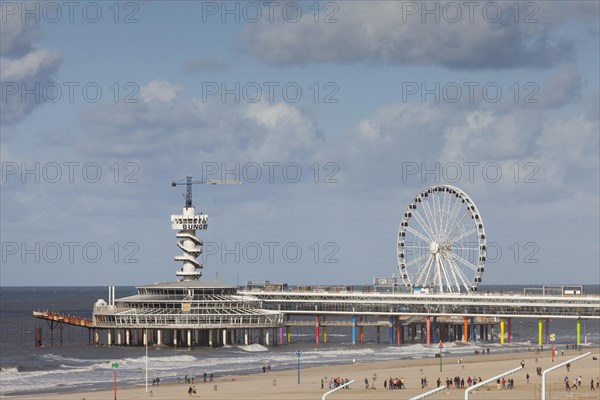 Pier with bungee jumping tower and Ferris wheel