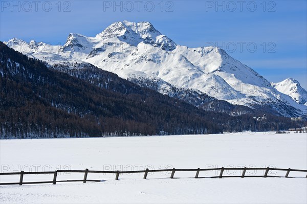 Summit Piz de la Margna above the frozen Lake Silvaplana