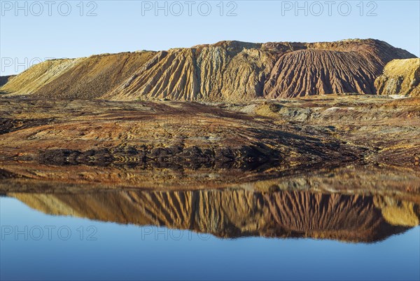 Mineral-rich ground and rocks with rainwater pool at Rio Tinto mines