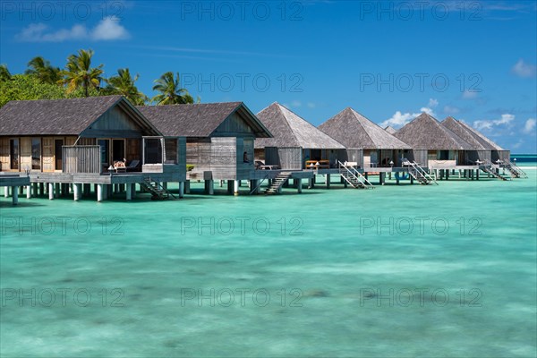 Wooden huts on stilts in lagoon