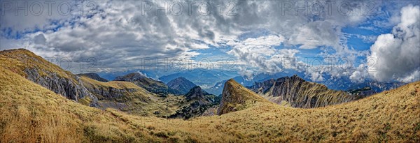 Panorama with bizarre cloudy sky from the summit of Hochiss in the Rofan Mountains with Dalfazer walls