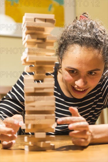 Young woman plays Jenga