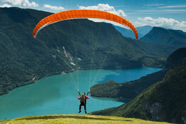 Paraglider starting above Molveno Lake