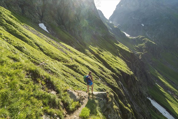 Hiker on a trail in the sunshine