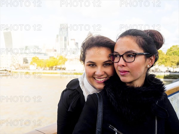 Two young women on a bridge