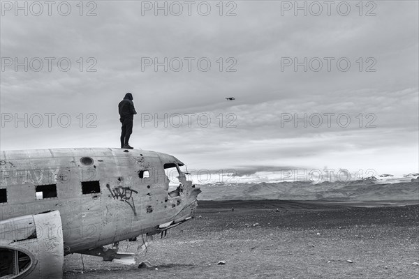 Man on aircraft wreck Douglas DC-3 controls Drone