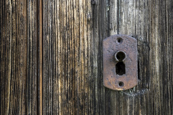 Lock on weathered wooden wall