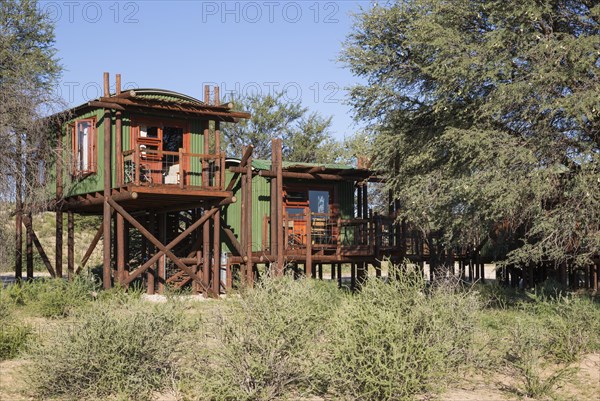 Urikaarus Wilderness Camp with stilt cabins at bank of dry Auob riverbed