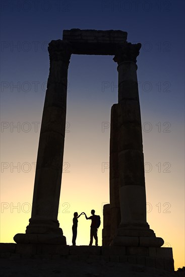 Couple forms a heart in sunset at the Temple of Hercules at the Citadel