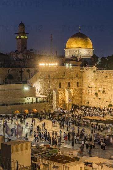 Believers at the Wailing Wall at dusk