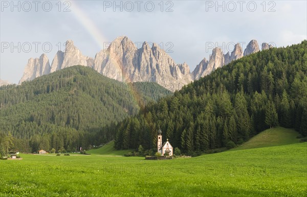 Rainbow in front of the church St. Johann in Ranui