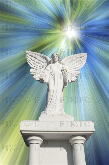 White angel statue with blue and white rays
