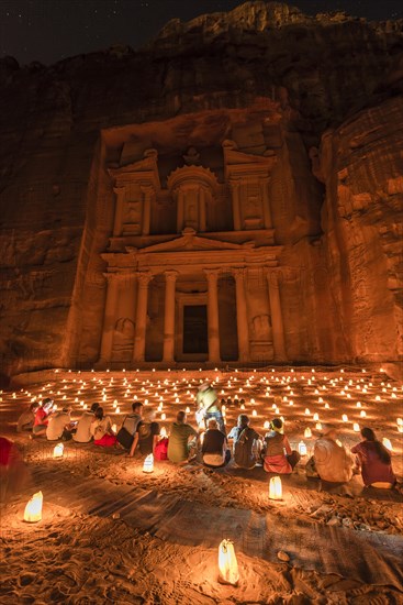 People sitting in front of candles