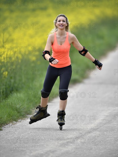 Inline skating alongside blooming rape field