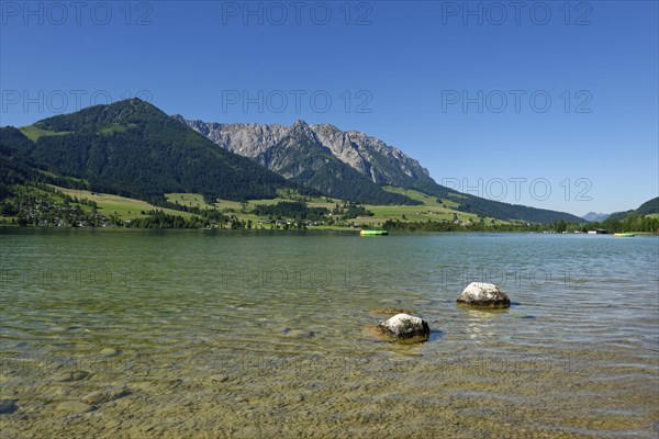 Lake Walchsee in front of mountain range Zahmer Kaiser