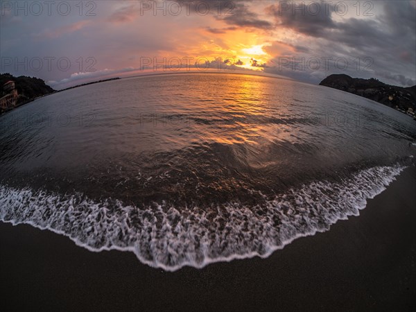 Sunset behind clouds over the sea