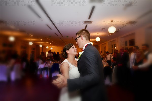 Young bridal couple dancing waltz