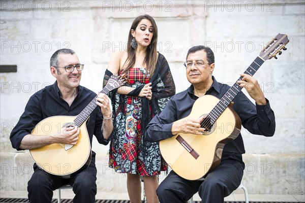 Fado band performing traditional portuguese music on the square of Alfama