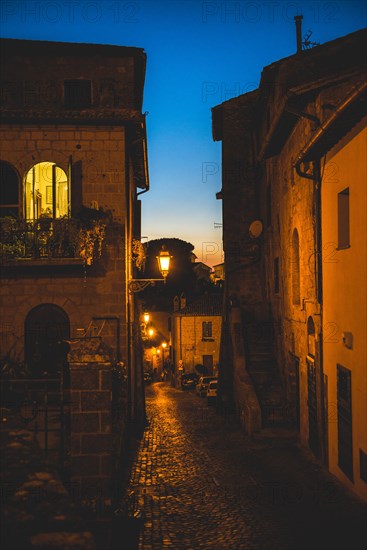 Narrow illuminated alleyway in the old town