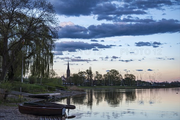 Rowboats by the lake at sunset