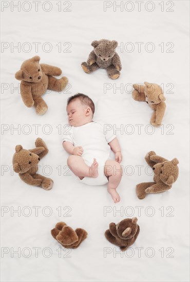 Baby sleeping with teddy bear Austria